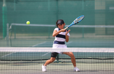 フォアハンドを打つジュニアテニスプレイヤー