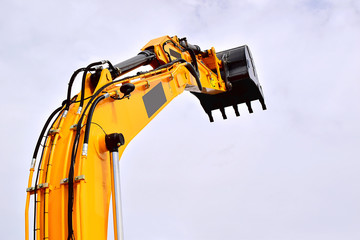 Hydraulic cylinder lifting bucket. Working equipment of a single-bucket excavator. Yellow. The...