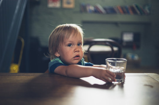 Little toddler at table in cafe