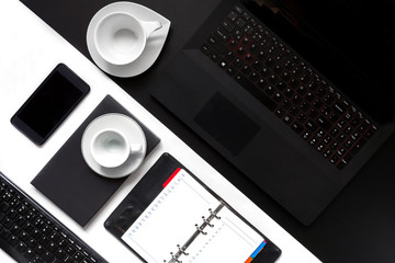 Black White office desk table with blank notebook, computer keyboard and other office supplies,business layout. Top view with copy space, flat lay.