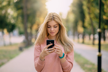 girl is using smartphone on street