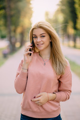 young girl speaks on phone outdoor