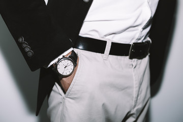 Closeup fashion image of luxury watch on wrist of man.body detail of a business man.Man's hand in...