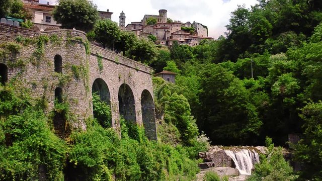 Castle of Bagnone view with waterfall, Tuscany, Italy