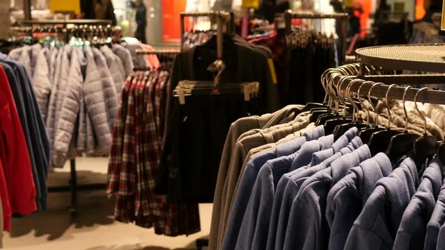Hangers with fashionable new clothes - shopping discounts in a boutique store 