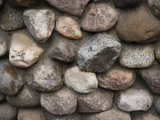 Fototapeta na wymiar Wall of large bulk stones. Colourful big stones. 
