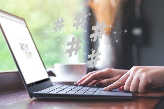 Woman using laptop with hashtag icon. Social media,hashtag concept..