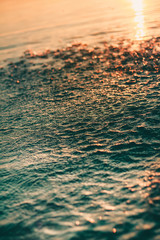 water surface with drops and splashes in the sunset and turquoise water  