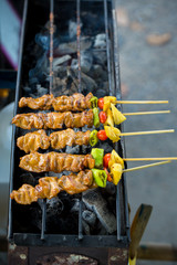 chef cooking at barbecue dinner buffet. Barbecue Grill Street Food in Thailand , Eat outdoors in a happy family.