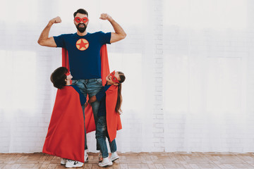 Young Family In Superhero Suits. Posing Concept.
