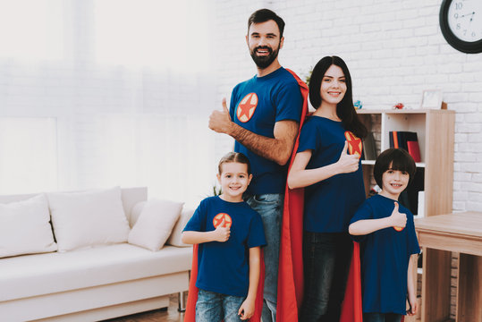 Young Family In Superhero Suits. Posing Concept.