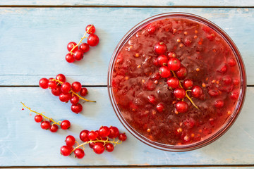 Cranberry sauce in bowl for Thanksgiving dinner on blue wooden table. Top view
