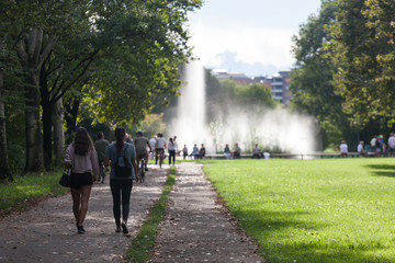 View of a fountain with peoples walking at the north park in Milan