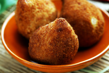 Coxinha street food. Brazilian Chicken Coxinha over rustic background.