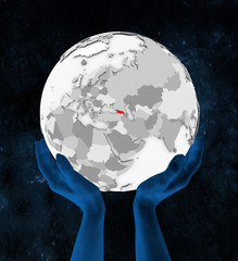 Georgia on white globe in hands