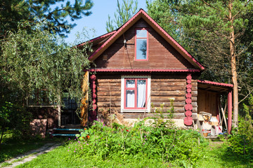 Fototapeta premium front view of country log house on summer day