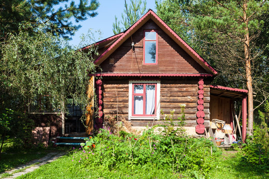 front view of country log house on summer day