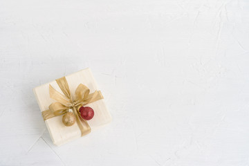 White gift or present boh with Christmas decoration on white background. Copy space, top view