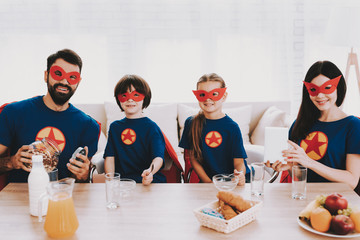 Young Family In Superhero Suits. Dinner Concept.