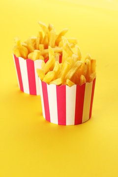 Potatoes French Fries in Red and white Carton Package Box. Fast Food.