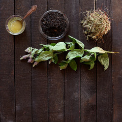 tea, Melissa, mint and honey on dark wooden background