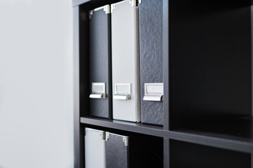 Black and white binders. File cabinets in office. File folder documents. Interior, office concept.