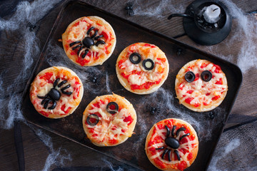 Mini pizza for Halloween with spiders, mummy and spider web, horizontal