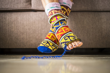 closeup of pair of feet with happy and nice broken socks with hole. fingers visible. artistic and coloured concept representing happy and freedom lifestyle for young and modern millennial people