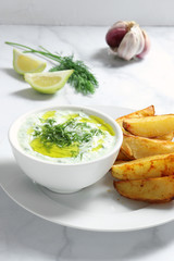 Tzatziki sauce with baked potatoes
