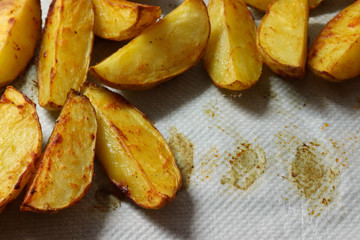 Freshly baked potato pieces on baking tray