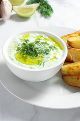 Tzatziki sauce with baked potatoes