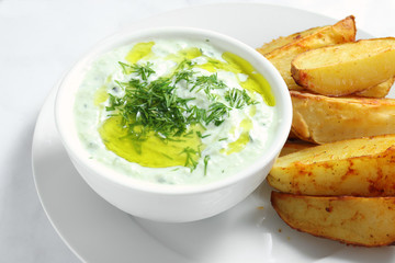 Tzatziki sauce with baked potatoes