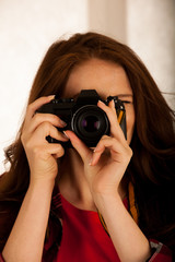 attractive beautiful woman holding a retro camera
