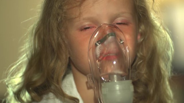 Sick Child Girl Smiles After Breathing Through Nebulizer. Asthma.