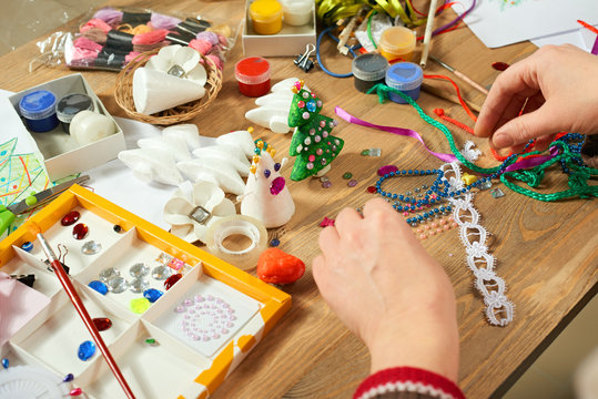Childrens making decorations for new year holiday. Painting watercolors. Top view. Artwork workplace with creative accessories.