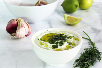 Freshly prepared tzatziki sauce, on white marble