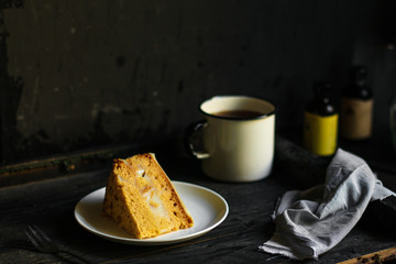cake a piece, with cream on a white plate. Top view rosemary. food background