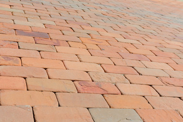Pavement made of red, dark red and orange bricks