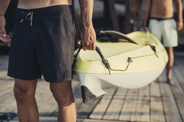 Two Men Carrying a Kayak