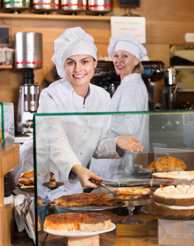 Hospitable women at bakery display