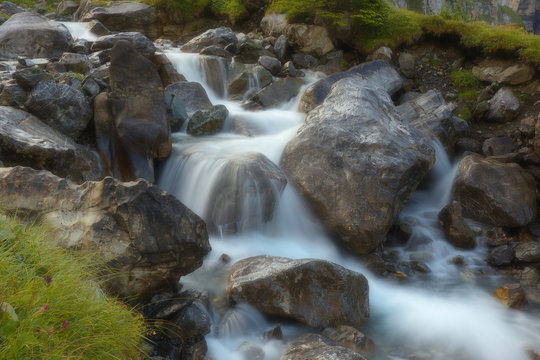 Mountain brook with flowing water on the stones, long exposition, version with a soft filter