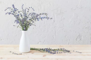 Fotobehang lavender in white vase on wooden table © Maya Kruchancova