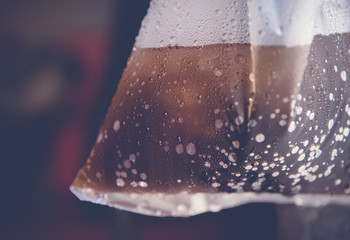 Closeup Steam of coca cola in plastic bag on Vintage tone