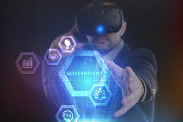 The concept of business, technology, the Internet and the network. A young entrepreneur working on a virtual screen of the future and sees the inscription: Government