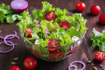 A glass salad bowl with a Greek salad