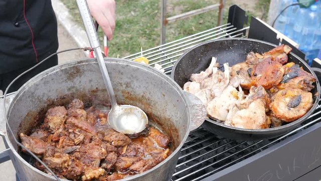 Boiling and frying a meat in a street food fair market