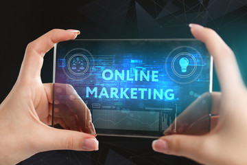 The concept of business, technology, the Internet and the network. A young entrepreneur working on a virtual screen of the future and sees the inscription: Online marketing