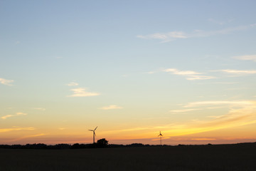 Wind turbines at a field for agriculture in the island of Jylland, Denmark.