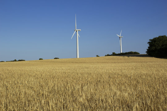 Wind turbines at a field for agriculture in the island of Jylland, Denmark.