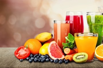 Fototapeta na wymiar Tasty fruits and juice with vitamins on